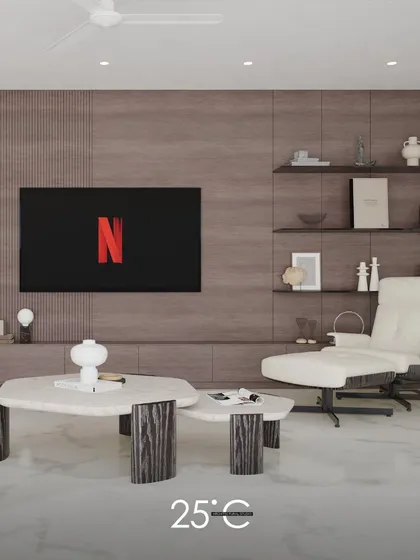 A detail shot focusing on a comfortable reading corner. The image highlights the plush off-white lounge chair and the uniquely designed nested coffee tables, emphasizing our commitment to creating stylish and functional nooks for relaxation.