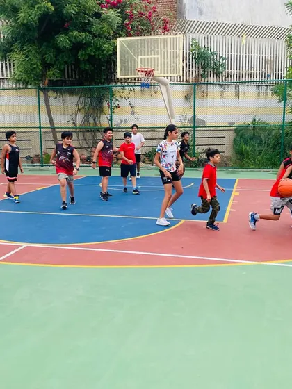 A junior player drives to the basket during a drill.