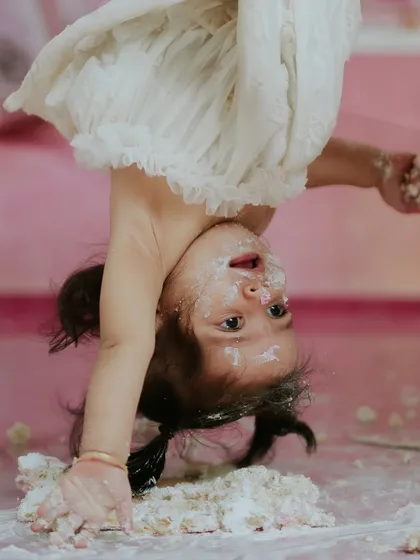 Sometimes you get so excited you could flip. This playful, upside down moment perfectly captures the wild and wonderful energy of a one year old.