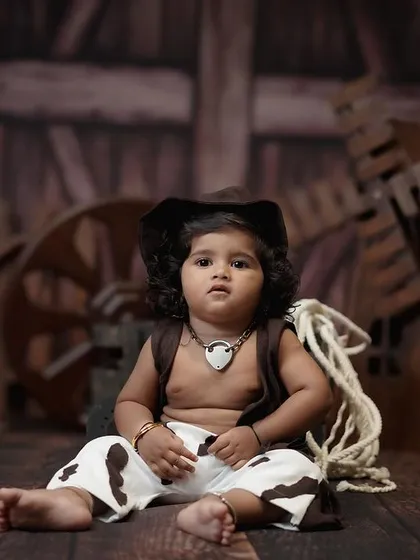 This cowboy-themed shoot was for a first birthday. The rustic backdrop and props create a unique and memorable way to celebrate the 'ONE' milestone.