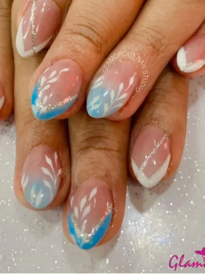 A beautiful and delicate design featuring a blue and white ombré base with hand-painted white leaves and a touch of silver glitter.