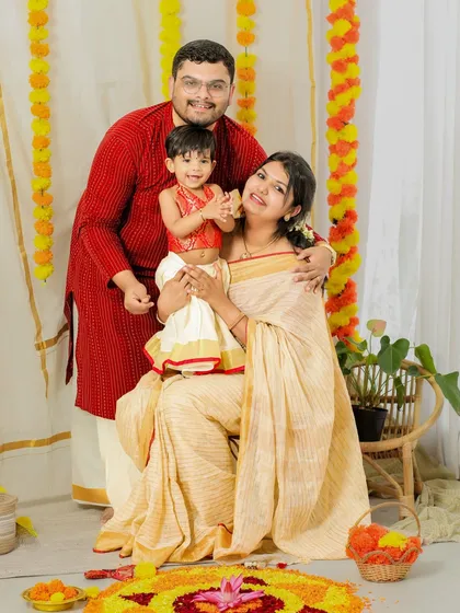 A festive family moment. This Onam-themed portrait captures the love and joy of a family celebrating their traditions together.
