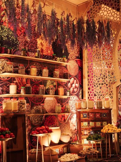 To create an authentic Moroccan spice market, we designed a backdrop with a vibrant spice print and built shelves filled with jars of real spices and hanging dried herbs. The sights and smells made the experience truly immersive.
