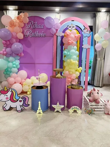 This pastel unicorn theme is perfect for a magical birthday celebration. The setup includes a rainbow arch backdrop, pastel balloon garlands, cute unicorn cutouts, and themed plinths, creating a dreamy atmosphere for the party.