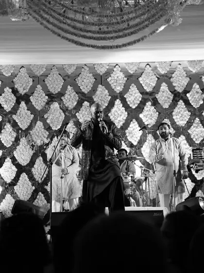 A classic black and white shot of a live Sufi band creating a magical mehfil. The intricate floral backdrop and the singer's passionate performance transported guests to a world of spiritual ecstasy.
