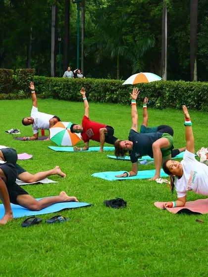 Our Independence Day workout included a full yoga and mobility session. Here, the group holds a side plank variation, building core strength and stability together.