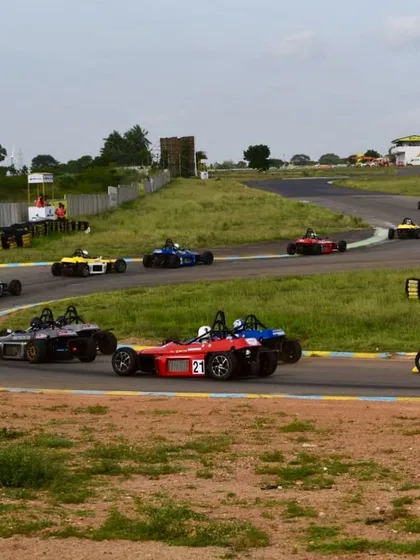 A wide shot of a Formula LGB race, with our red number 21 car navigating through a crowded field of competitors.