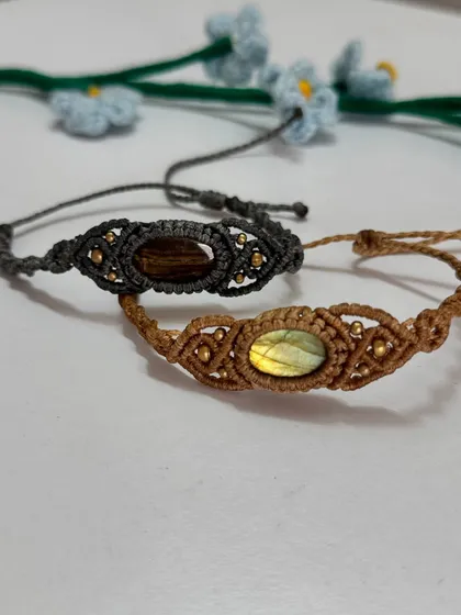 I often get asked for gift options for men, so I created these unique macrame bracelets. This collection features earthy tones of brown and grey cotton cord, intricately knotted around a central gemstone with small brass bead details.