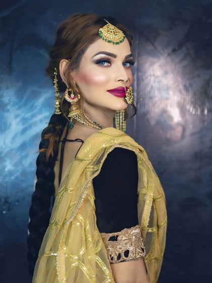 A dramatic and captivating look. The combination of a bold magenta lip, smokey eyes, and the intricate nath creates a powerful and unforgettable style.