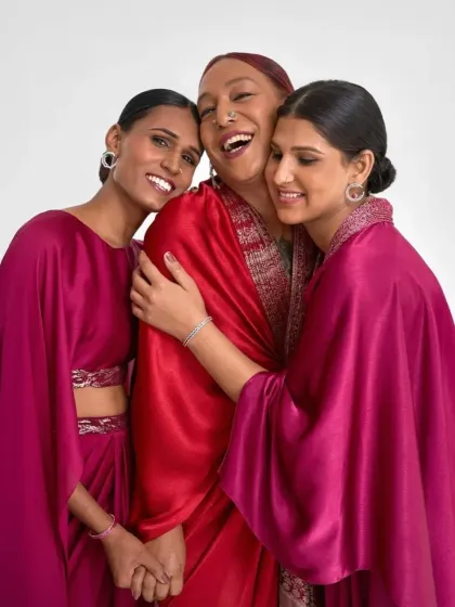 A moment of connection during the shoot. The makeup for all three women was designed to be harmonious yet individual, using radiant skin and defined features to complement the couture.