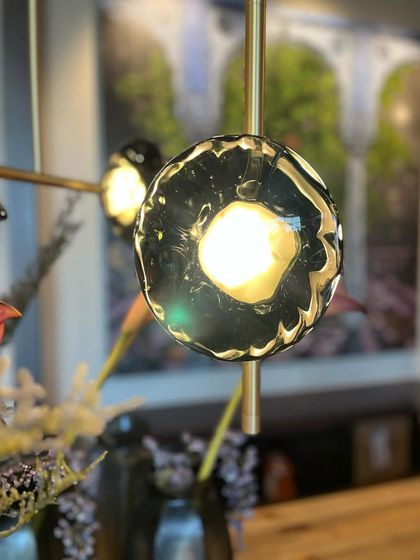 A beautiful portrait shot of a single Ceto glass shade, capturing the depth and texture created by the optic glass blowing technique.