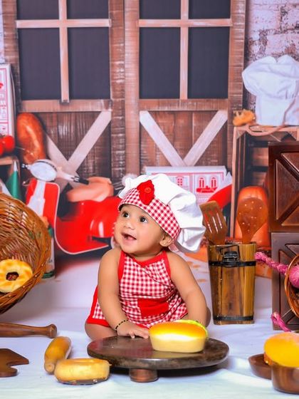 A wide-angle view of our popular baby chef theme, showing the full extent of the fun and detailed props we use to create this adorable kitchen scene.