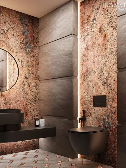 Another angle of the Red Ruptura stone washroom. This view highlights the contrast between the raw, textured stone and the sleek, modern fixtures, showcasing a balance of earthy richness and contemporary design.