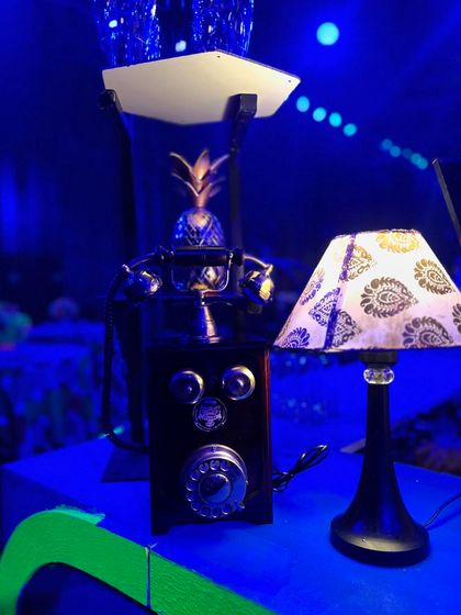 Another retro detail for our vintage theme. A classic rotary telephone prop sits on the bar, adding a touch of nostalgia to the modern, neon-lit setting.