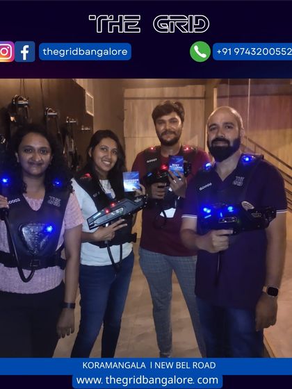 A team of four poses with their laser guns, ready for their next match.