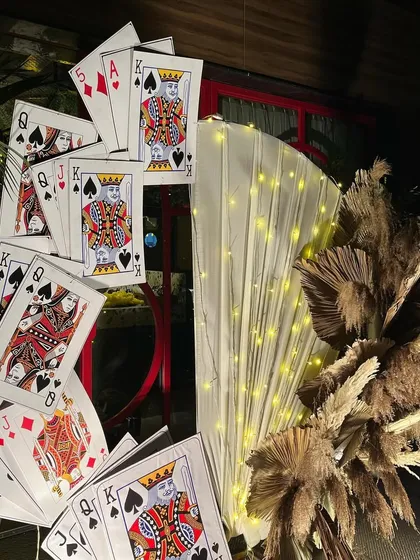 Another look at our creative photo corner for a card party, combining modern boho elements like pampas grass with the fun theme of playing cards.