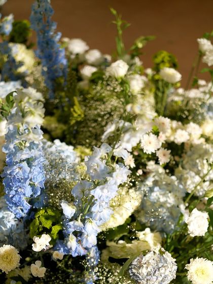 A close-up of the delicate blue and white florals used in the feather-themed wedding.