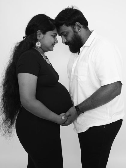A powerful black and white image of the couple holding hands and connecting. This pose symbolizes their partnership and the journey they are on together.