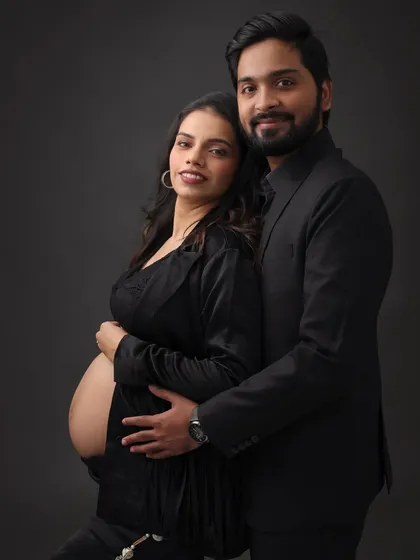 A classic and elegant black-and-white themed maternity shoot. The makeup is sophisticated and timeless, creating a powerful and intimate portrait.