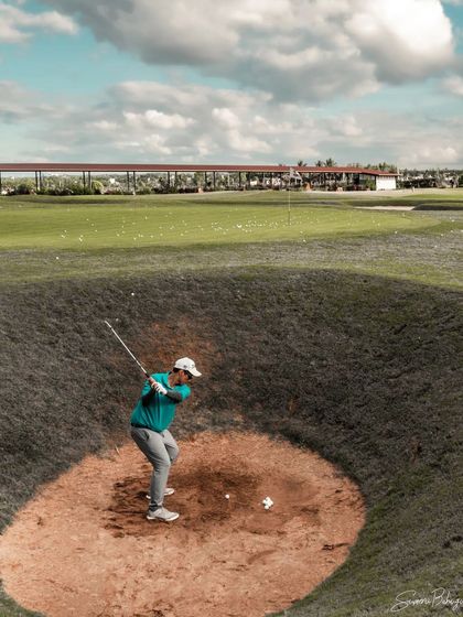 A mid-swing shot from inside the pot bunker, highlighting the challenging practice scenarios we offer to improve every aspect of your game.