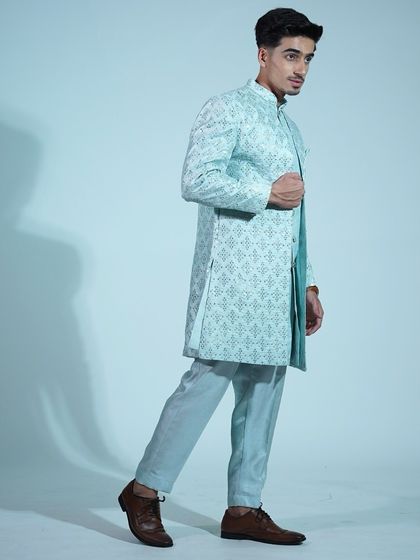 A side view of the light blue sherwani, showing how the asymmetrical cut adds a modern twist to the traditional silhouette.