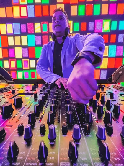 A creative shot of me at the console against a colorful, retro-style LED wall. The visual production of an event is a huge part of the overall experience.