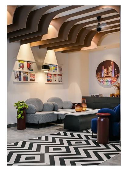 The waiting lounge, showing the custom magazine racks and ceiling detail.