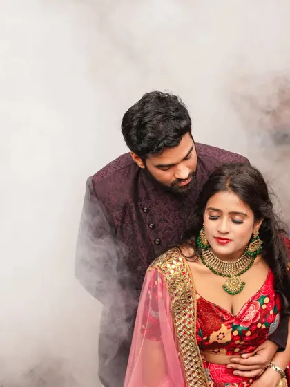 In this intimate portrait, the focus is all on their connection amidst the grandeur of the location. The soft smoke and their traditional attire come together to create a romantic, almost poetic pre-wedding photograph.