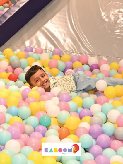 That smile says it all! There's nothing like the simple joy of being surrounded by hundreds of colorful balls.