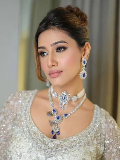 Another angle of this captivating cocktail makeup. The way the light hits the highlighter on her cheekbones and brow bone adds to the overall glamorous effect.