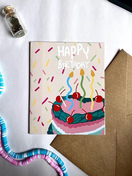 A classic "Happy Birthday" card with a colorful cake and sprinkles design. It's a simple, cheerful, and perfect addition to any birthday gift.