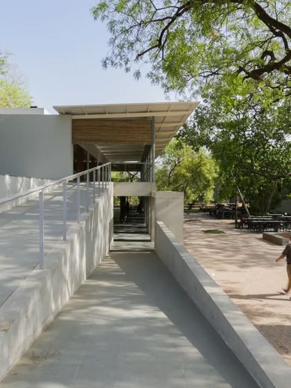 The accessible ramp leading to the CEPT University Canteen is integrated into the landscape design. It provides a gentle, sloping path that connects different levels of the site, ensuring easy access for all.