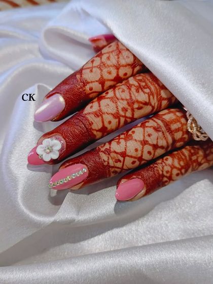 Pretty in pink for this wedding look. I used a solid pink polish and created accent nails with a row of delicate rhinestones and a hand-sculpted 3D white flower.