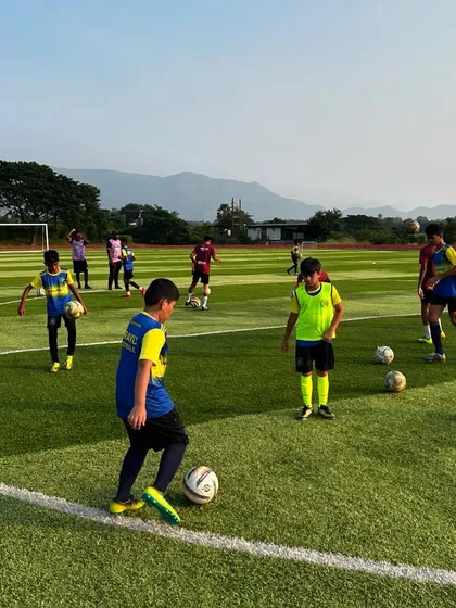 Young players participate in a dribbling drill during our Diwali Football Camp. The image shows the fun and focused atmosphere created when you combine great coaches and enthusiastic children.