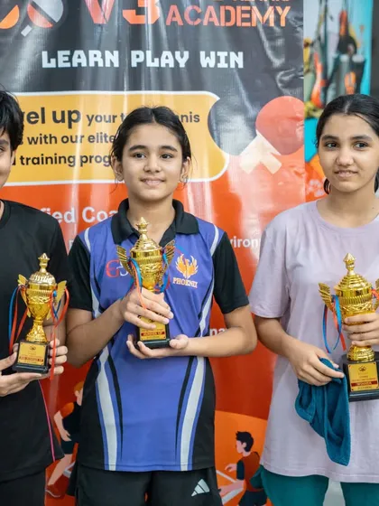 Three champions from our U-11 and U-13 girls' categories holding their well-earned trophies. I focus on creating a fair and encouraging environment where young talent can shine.