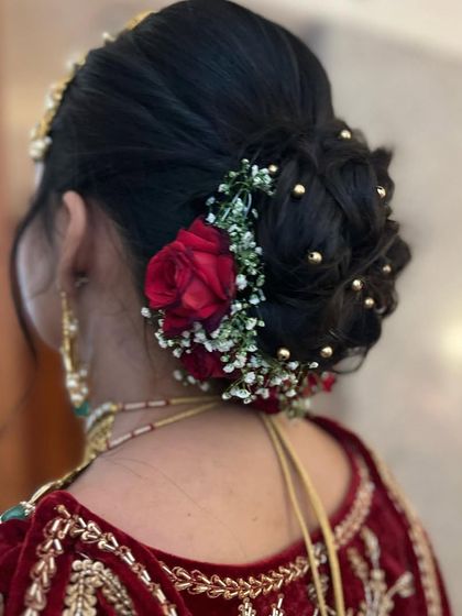 Another angle of this red rose bun, showing the messy, textured finish that gives it a modern and romantic feel.