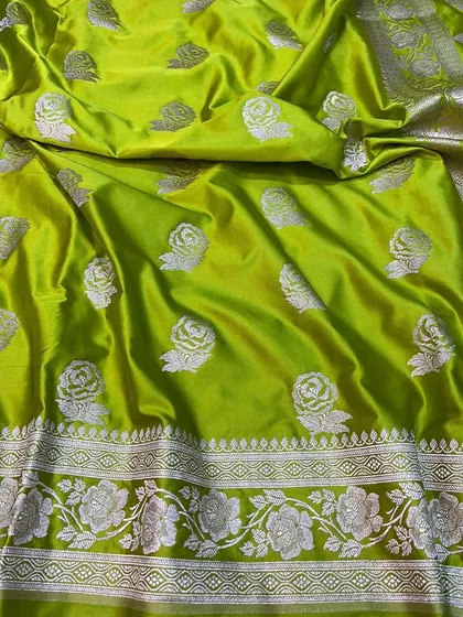 A vibrant lime green Mashru silk saree with silver rose motifs.