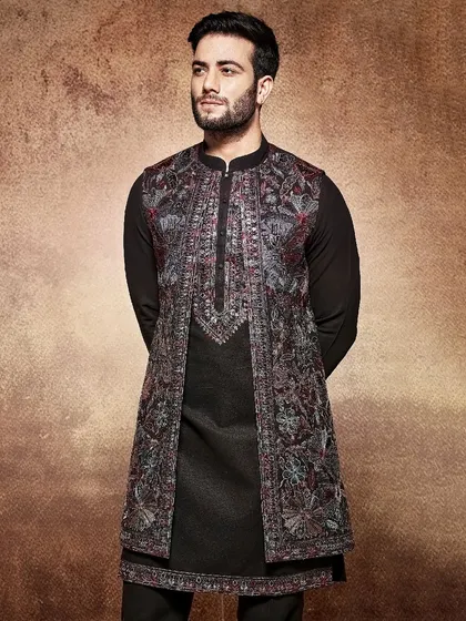 Regal and sophisticated, this black kurta is paired with an open jacket featuring intricate, multi-tonal embroidery. It's a perfect choice for a grand reception or formal event.