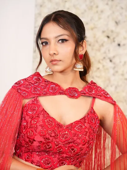 This portrait captures the modern yet timeless feel of the entire look, from the chic ponytail to the radiant, soft-focus makeup.