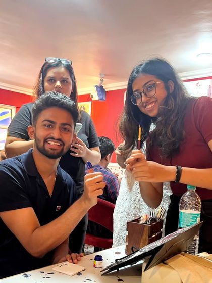 A duplicate of the group getting creative with a painting activity organized by our host club in Pune.