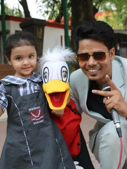 It's not just about Rancho the monkey. I bring a whole family of puppets to my shows, like Ducky here. This photo with a student from St. Martin's School shows the instant connection my characters make with young children, making every performance a memorable one.