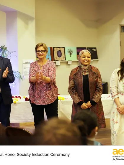 Faculty members applaud the newly inducted students. The pride and support of our teaching community are central to our students' success.