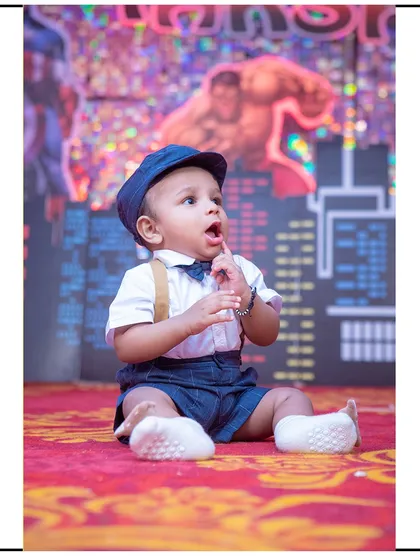 A curious look from this little boy during his superhero-themed photoshoot. The dynamic background adds a lot of energy to the portrait.