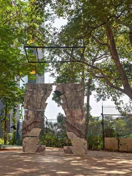 An abstract stone art installation with a cutout 'A' for our firm. This piece plays with perception and materiality, creating a powerful statement about our brand's connection to the earth and design.