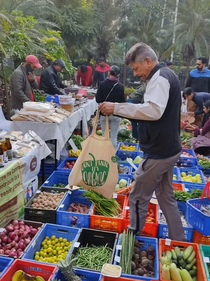 A customer with a "Don't Panic, It's Organic" bag, embodying the market's ethos.