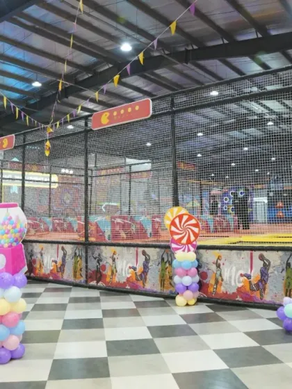 A wide shot showing how our themed decorations integrate with the play area. The candy-themed balloon columns add a festive touch throughout the space.