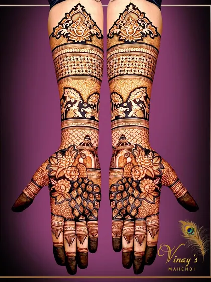 A traditional full-hand design with peacocks on the palms and dancing figures on the arms, creating a festive and vibrant look.