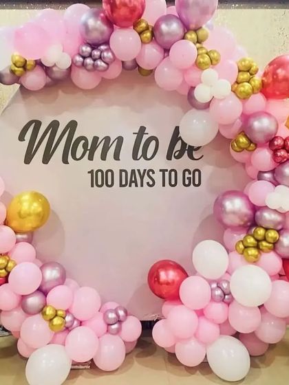 A "Mom to be" countdown celebration backdrop, featuring a circular frame with a beautiful pink, white, and chrome balloon garland.