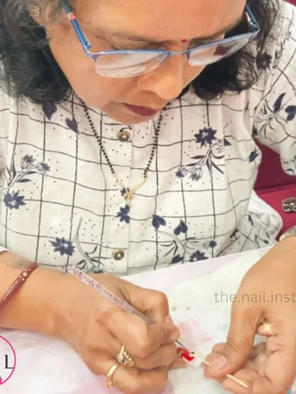 This student is learning to create detailed nail art, practicing her fine motor skills with a small brush.
