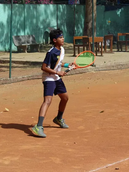A junior player focused on the ball during a rally. Keeping your eye on the ball is the first rule of tennis.